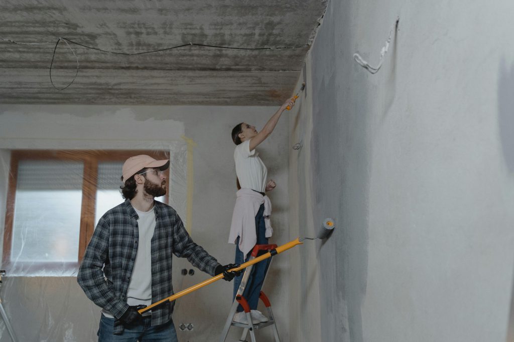 A couple painting the walls