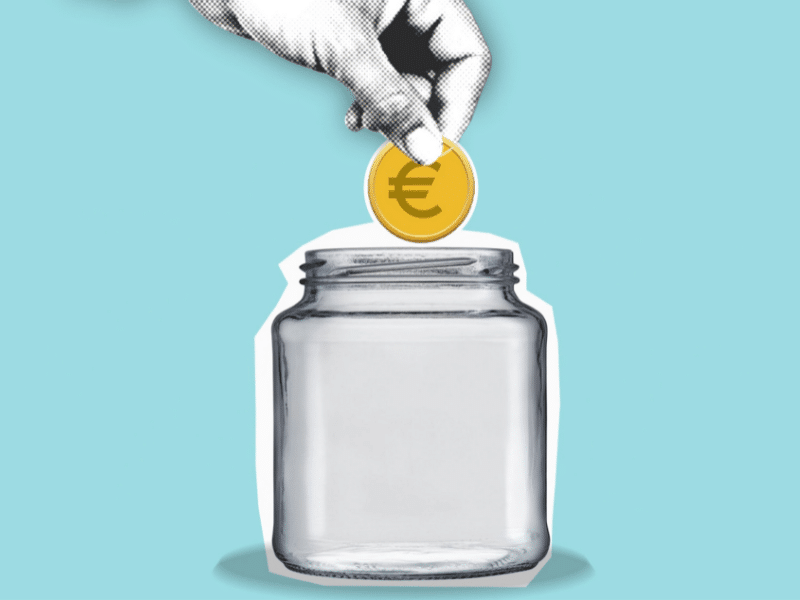 This is a hand placing a coin into a jar.