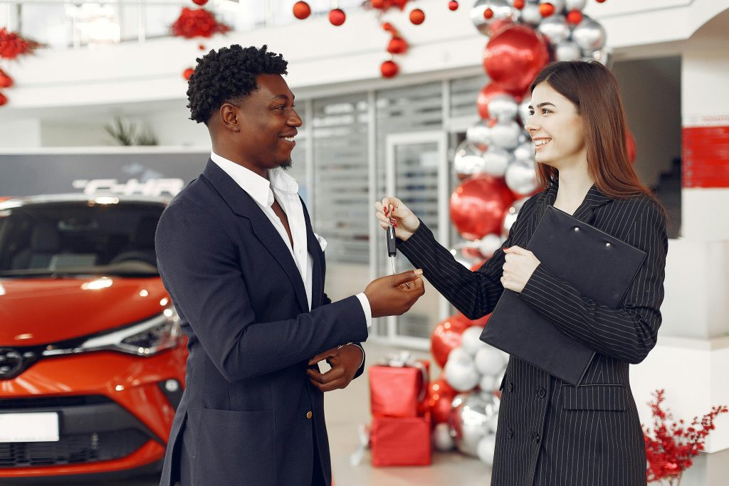 Car dealers discussing how to get an auto loan.