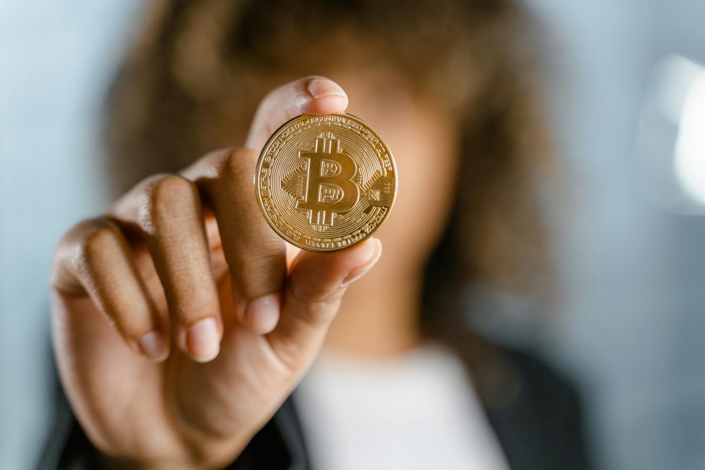A woman holding a Bitcoin